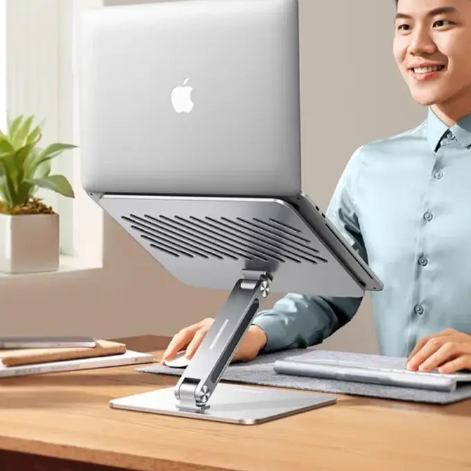 MacBook en position haute — écran au niveau des yeux, bras détendus
